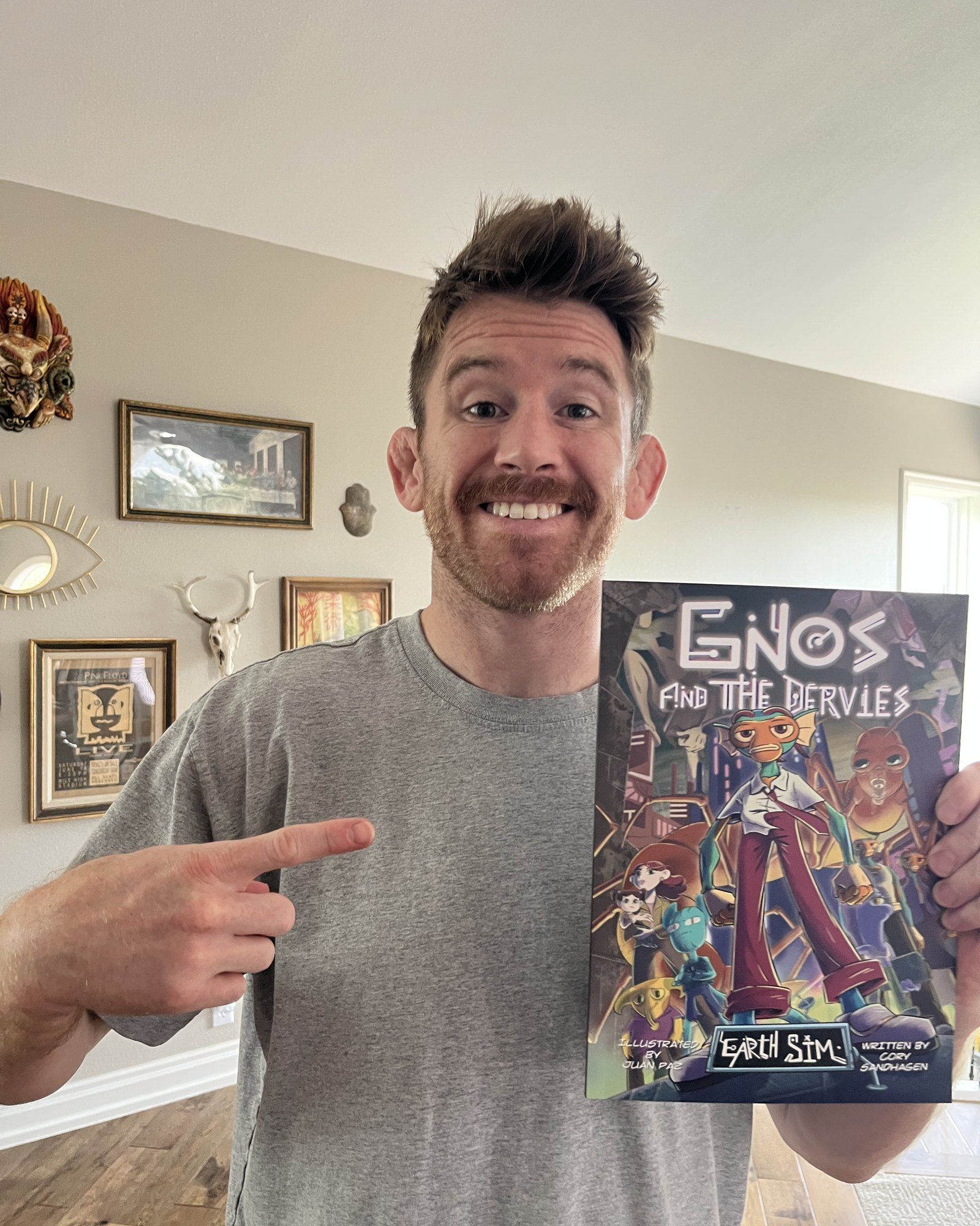 Cory Sandhagen holding a printed copy of Gnos and The Dervies and pointing at the cover. He is saying: in between UFC fights I really love writing comic books, this is my first completed piece.